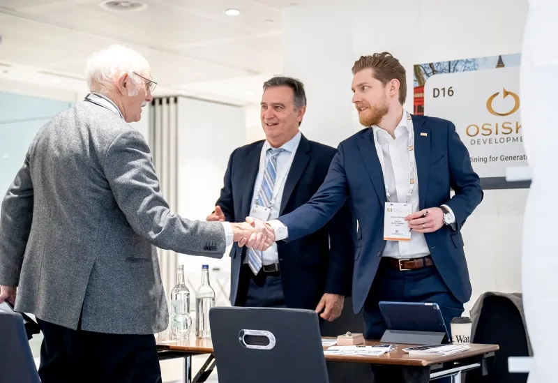 Mining industry professionals shaking hands during a private meeting at a 121 event