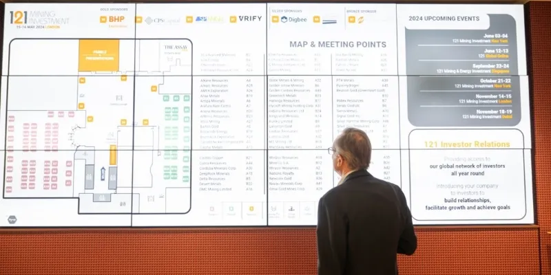 Attendee reviewing the event floorplan and meeting directory at 121 Mining Investment London