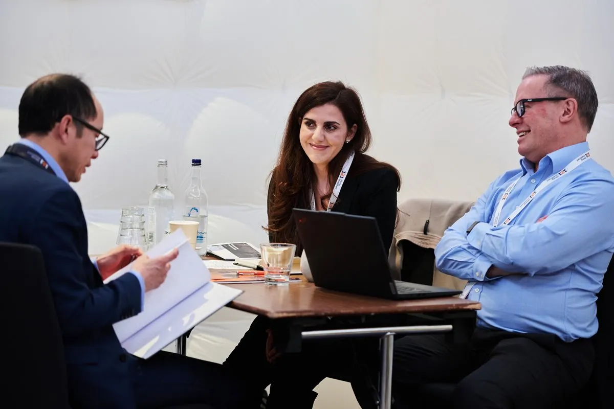 Mining industry professionals discussing investment opportunities during a 1-2-1 meeting